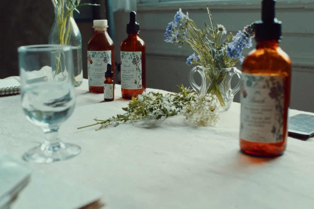 Amber dropper bottles beside wild flowers