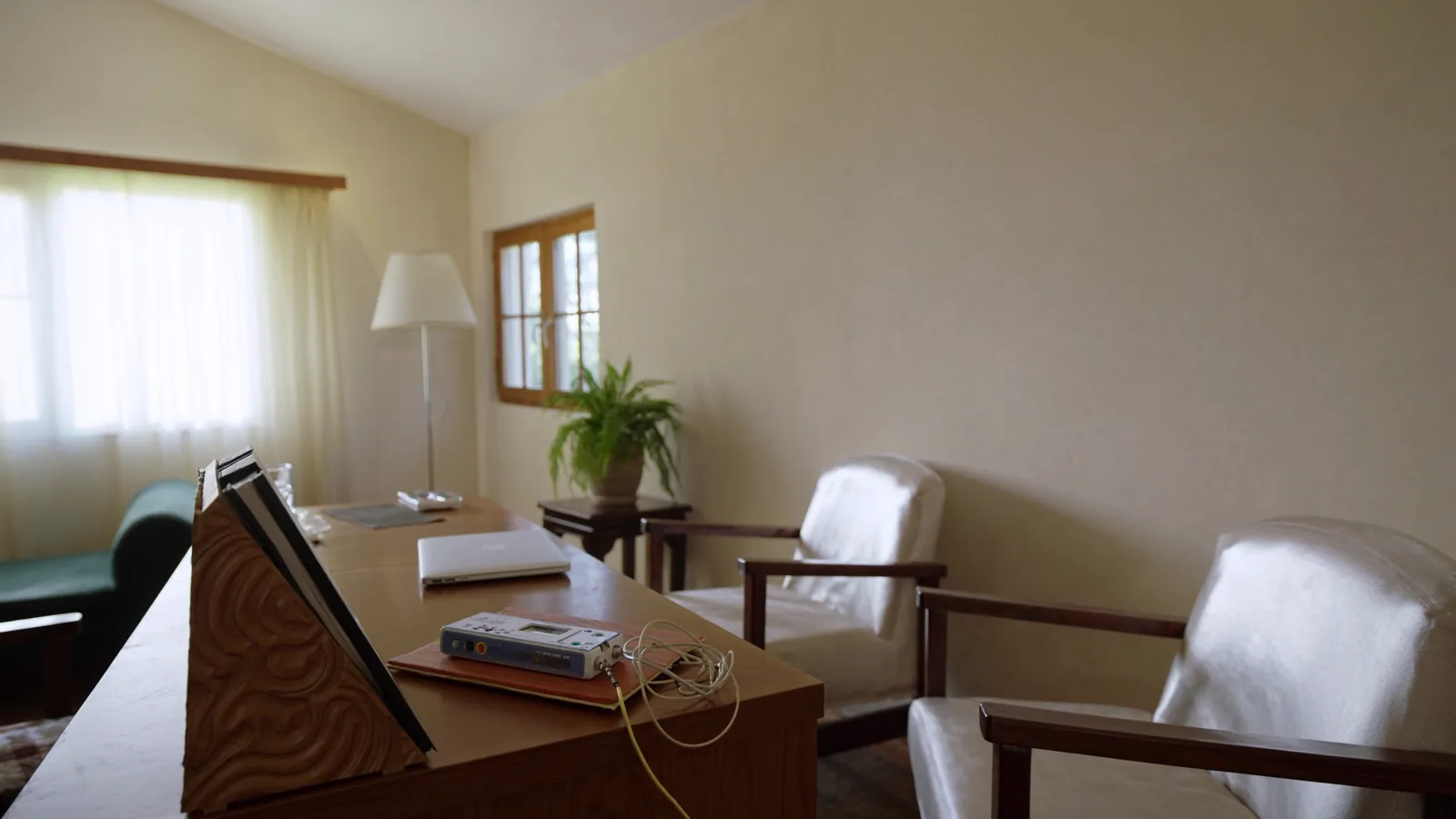 The consulting room: desk with the biofeedback unit, two armchairs, morning light