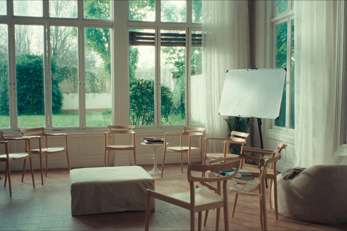 A bright workshop room with a circle of chairs